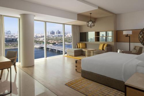 a bedroom with a large bed and a living room at Marriott Marquis Dubai in Dubai