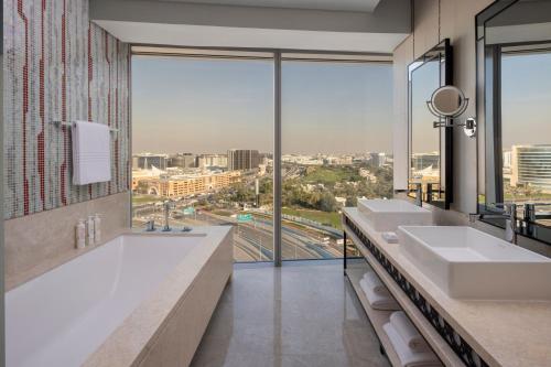 a bathroom with two sinks and a large window at Marriott Marquis Dubai Creek in Dubai