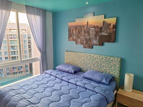 sypialnia z łóżkiem z obrazem na ścianie w obiekcie Atlantis Condo Resort w mieście Jomtien Beach