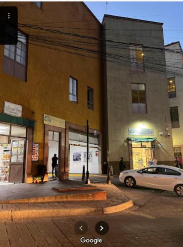 a white car parked in front of a building at Casa del Temezcuitate in Guanajuato