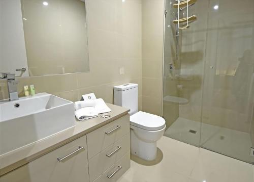 a bathroom with a sink and a toilet and a shower at Salt 5 Sorrento walk to beaches shops cafes and restaurants in Sorrento