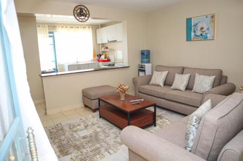 a living room with a couch and a table at Kigoma Suites in Nyahururu