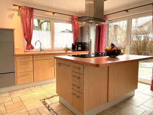 a kitchen with a large island in the middle at Haus Leni in Fischen