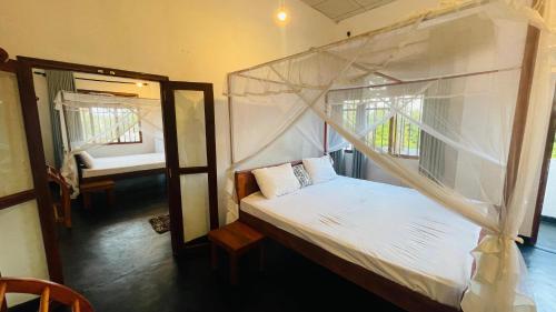 Postel nebo postele na pokoji v ubytování Villa Don Williams Weligama