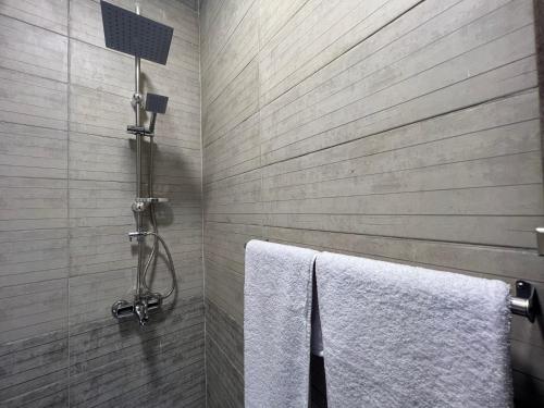 a bathroom with a shower with two white towels at Lux pyramids View Inn in Cairo