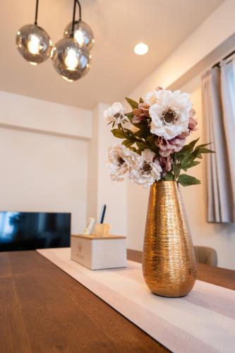 a vase filled with flowers sitting on a table at N262walk 3 minutes to Osu shopping street stay 8 people in Aoichō