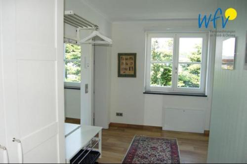 ein Wohnzimmer mit weißen Wänden und einem Fenster in der Unterkunft Ferienhaus Rademacher Ferienwohnung 1 in Binz