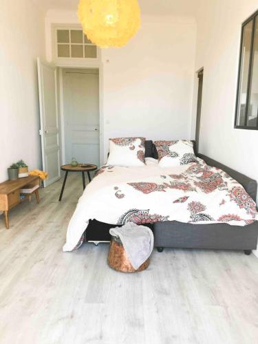 a bedroom with a large bed and a table at Charming Studio In The Heart Of Menton in Menton