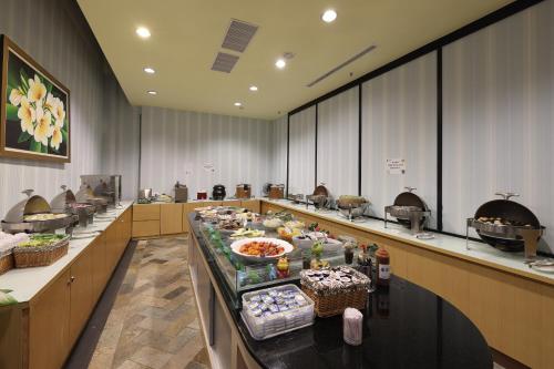 a buffet line with food on display in a restaurant at Shante Hotel Shitou in Lugu