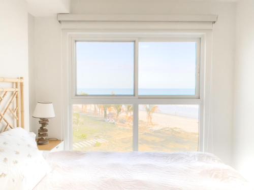 Ένα ή περισσότερα κρεβάτια σε δωμάτιο στο Ventanas del Mar by Playa Caracol Residences