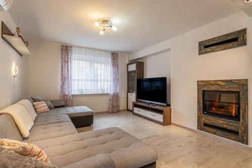 a living room with a couch and a fireplace at House Dijana With Pool - Happy Rentals in Nova Vas