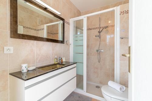 a bathroom with a shower and a sink and a toilet at Superb Rooftop Roquebrune Parking in Roquebrune-Cap-Martin