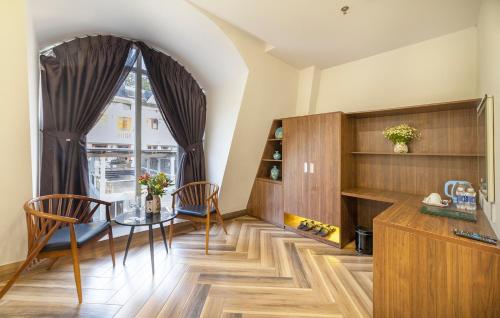 a dining room with a table and a window at TALA Dalat Hotel in Da Lat