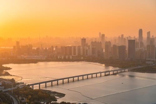 a bridge over a body of water in front of a city at Wuhan Marriott Hotel Wuchang in Wuhan
