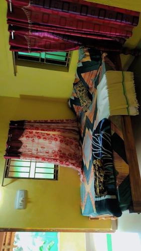 a room with a bunch of different colored blankets at Deepu Guest house in Gokarna