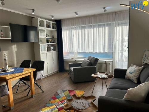 a living room with a couch and a table at Holiday Residenz II Ferienwohnung Möwennest in Borkum