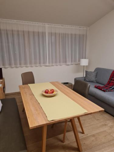 a living room with a table with a bowl of fruit on it at Versigglhof in Appiano sulla Strada del Vino
