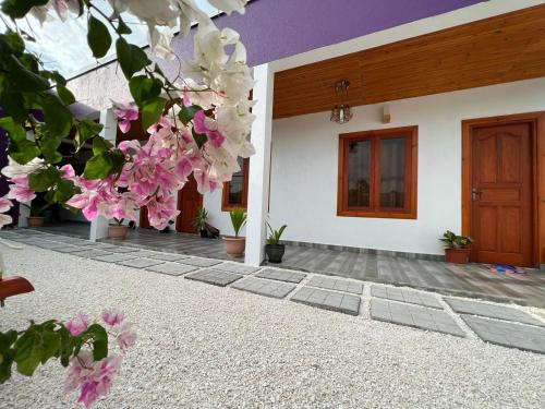 a house with pink flowers in front of it at Villa Oneocean in Kondey