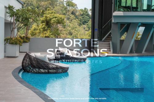 a swimming pool in a building with a sign that reads future seasons at Enclave Nature Suites @ Bukit Tinggi in Bentong