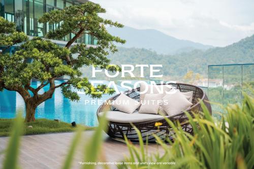 a wicker chair in front of a building with a tree at Enclave Nature Suites @ Bukit Tinggi in Bentong