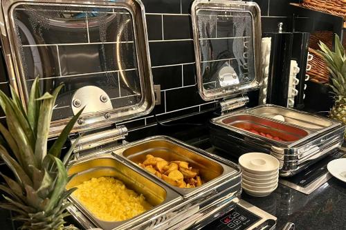 two trays of food sitting on a kitchen counter at Woxx Hotel in Istanbul