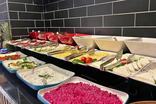 a buffet with many different types of food in trays at Woxx Hotel in Istanbul