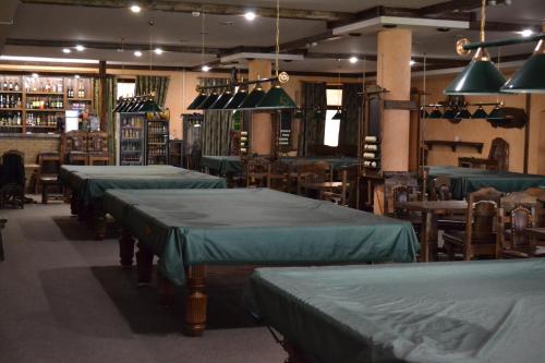 a room with rows of beds and tables and chairs at Mini Otel Spokoyny Otdyh in Stavropol