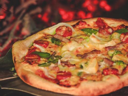 a pizza sitting on top of a table at 民宿みやま in Ōno