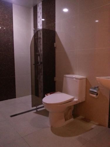 a bathroom with a toilet and a shower at shillahotel and resort in Angeles