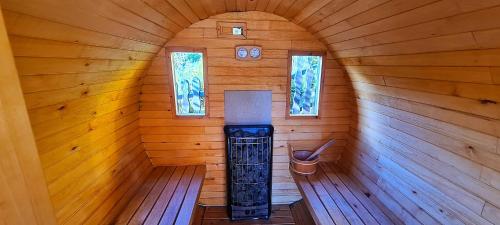 an inside view of a wooden cabin with a stove at Willa Bimbrówka in Wisła