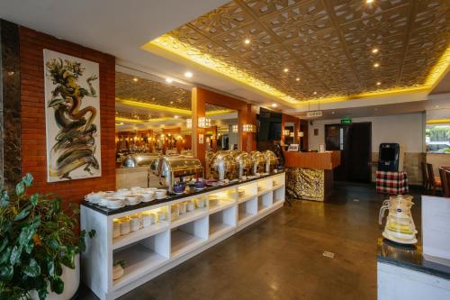 a store with a counter with a lot of desserts at Horison Ultima Seminyak Bali - CHSE Certified in Seminyak