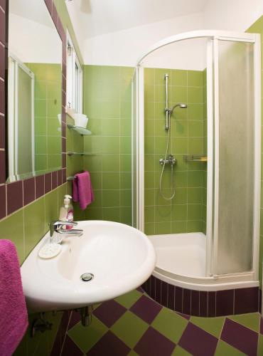 a bathroom with a sink and a shower at Studio Apartments Andrijana in Mlini