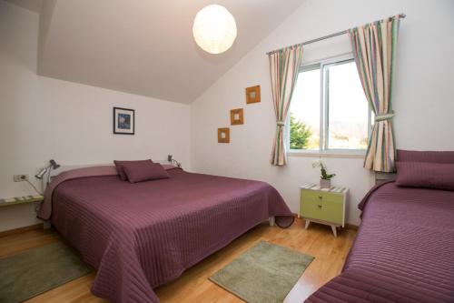 a bedroom with two beds and a window at Studio Apartments Andrijana in Mlini