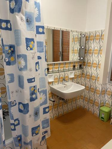 a bathroom with a sink and a mirror at Wohnung mit grandiosem Ausblick in Tremosine Sul Garda