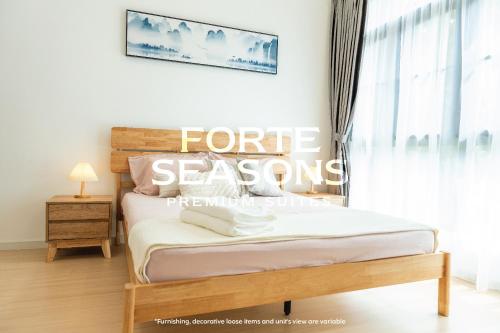 a bedroom with a bed and a window with the words future season at Enclave Nature Suites @ Bukit Tinggi in Bentong