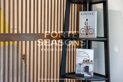 a book shelf with books and a bike on it at Enclave Nature Suites @ Bukit Tinggi in Bentong