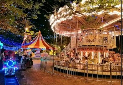 a merry go round at a carnival at night at Bench/seaviews4-13pax/JohorBahru 9B amberside in Johor Bahru