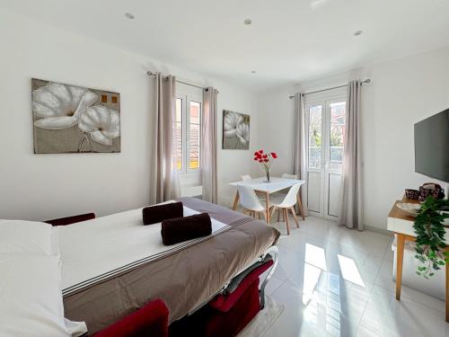 une chambre avec un lit et une table dans une pièce dans l'établissement Tivoli 3 - Renovated 2 bedrooms appartment, Nice terrace, Monaco Border, 5mn from Casino Monte Carlo, à Beausoleil