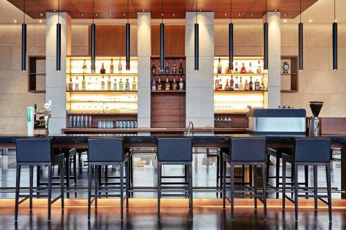 a bar in a hotel lobby with chairs at Courtyard by Marriott Seoul Pangyo in Seongnam