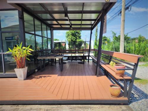 um pavilhão com bancos, mesas e janelas em T-NEE Hotel@Udon em Udon Thani
