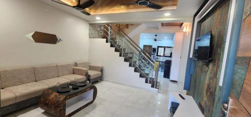 a living room with a couch and a staircase at Casa De Diu in Diu