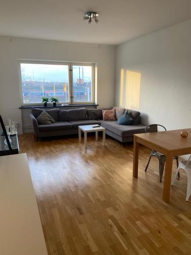 a living room with a couch and a table at Eurovision Finale 1BD in Malmö