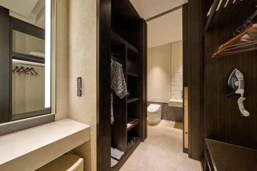 a walk in closet with a toilet in a bathroom at Banyan Tree Kuala Lumpur in Kuala Lumpur