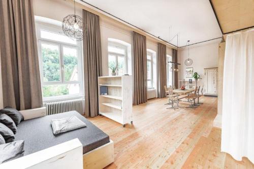 a living room with a bed and a table in it at NaturparkResort Alte Schule in Hieflau