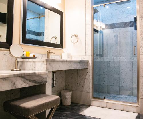 a bathroom with a sink and a shower at Norwalk Inn & Conference Center in Norwalk