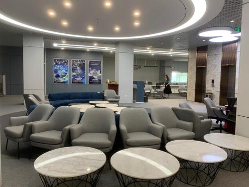 a waiting room with tables and chairs in a building at Phù Đổng Hotel Thanh Hóa in Thanh Hóa