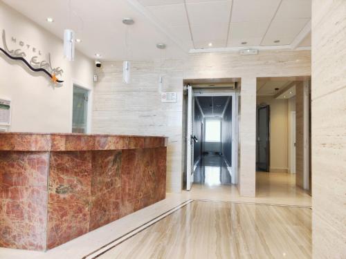a lobby of an office building with a stone wall at Hotel La Cala Finestrat in Cala de Finestrat