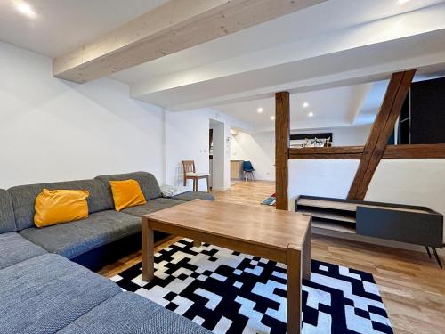 a living room with a couch and a table at Epfig Maison in Epfig