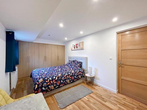 a bedroom with a bed and a wooden closet at Epfig Maison in Epfig