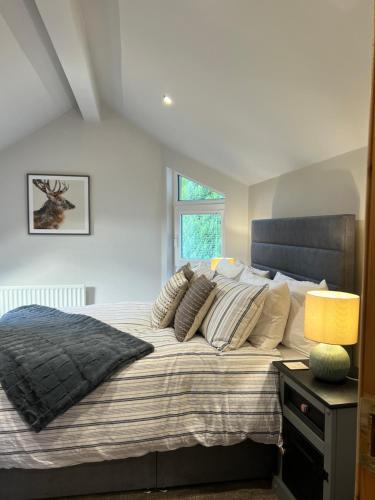 a bedroom with a large bed with a window at Hunters Glebe Country Apartment in Castlerock